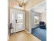 Inviting entryway with decorative glass door, wood-look floors, and adjacent living space at 1305 Santa Maria Ave, The Villages, FL 32159