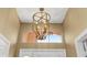 Stylish bronze foyer light fixture above the entry with a view of the arch at 1305 Santa Maria Ave, The Villages, FL 32159