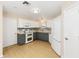 Charming kitchen with stainless appliances, white cabinets and stylish grey lower cabinets at 1305 Santa Maria Ave, The Villages, FL 32159