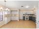 Spacious kitchen features white cabinets, light countertops, and stainless steel appliances at 1305 Santa Maria Ave, The Villages, FL 32159