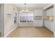 Eat-in kitchen area with bright windows, white cabinets, and modern lighting at 1305 Santa Maria Ave, The Villages, FL 32159