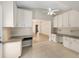 Bright kitchen with tile floors, white cabinets, neutral walls, and view of the adjacent living space at 1305 Santa Maria Ave, The Villages, FL 32159