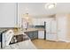 Bright kitchen features modern white appliances, stylish blue backsplash, and lovely countertops at 1305 Santa Maria Ave, The Villages, FL 32159