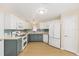 Updated kitchen with modern appliances, light countertops, and two-tone cabinets at 1305 Santa Maria Ave, The Villages, FL 32159