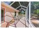 Covered and screened outdoor patio with comfortable seating overlooking the manicured yard at 1305 Santa Maria Ave, The Villages, FL 32159