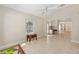 Bright living room features tile floors, high ceilings, and an open floor plan leading to the kitchen at 1305 Santa Maria Ave, The Villages, FL 32159