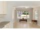 Open floor plan showcases a living area with tile floors, a ceiling fan, and a picturesque window view at 1305 Santa Maria Ave, The Villages, FL 32159