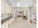 Open floor plan showcases a living area with tile floors, a ceiling fan, and a picturesque window view at 1305 Santa Maria Ave, The Villages, FL 32159
