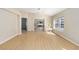 Bright living room features neutral walls, wood floors, ceiling fan, and natural light at 1305 Santa Maria Ave, The Villages, FL 32159