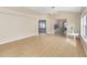 Bright living room features neutral walls, wood floors, ceiling fan, and natural light at 1305 Santa Maria Ave, The Villages, FL 32159