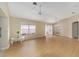 Bright living room with vaulted ceiling, wood floors, ceiling fan, and view of the outdoors at 1305 Santa Maria Ave, The Villages, FL 32159