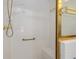 Shower with gold hardware, bench and tiled walls at 1305 Santa Maria Ave, The Villages, FL 32159