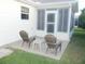 Cozy back patio with outdoor seating and adjacent access to the screened in porch at 1310 Jimenez Ct, The Villages, FL 32159