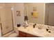 Inviting bathroom with a walk-in shower, vanity, and stylish coastal decorations for a serene retreat at 1310 Jimenez Ct, The Villages, FL 32159