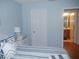 Bright bedroom with an ensuite bathroom access, featuring a coastal theme and bedside table at 1310 Jimenez Ct, The Villages, FL 32159