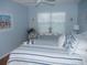 Relaxing bedroom with a nautical theme, showcasing a plush bed and inviting ambiance at 1310 Jimenez Ct, The Villages, FL 32159