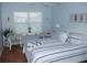 Cozy bedroom with coastal decor, featuring a comfortable bed and plenty of natural light at 1310 Jimenez Ct, The Villages, FL 32159