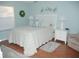Bright bedroom with white bedroom furniture, a queen bed and light blue paint at 1310 Jimenez Ct, The Villages, FL 32159
