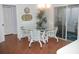 Cozy dining area with a glass table, seating for four, and access to the screened-in lanai at 1310 Jimenez Ct, The Villages, FL 32159