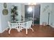 Bright dining area featuring a glass-top table, white chairs, and sliding glass doors to the lanai at 1310 Jimenez Ct, The Villages, FL 32159