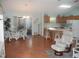 Open dining area with stylish furniture, chandelier, and seamless access to kitchen and lanai at 1310 Jimenez Ct, The Villages, FL 32159
