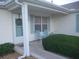 Inviting front porch with seating, coastal decor, and a well-maintained exterior at 1310 Jimenez Ct, The Villages, FL 32159