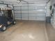 Spacious garage with a golf cart, open garage door, and room for multiple vehicles at 1310 Jimenez Ct, The Villages, FL 32159