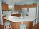 Bright kitchen with white countertops, breakfast bar, and well-lit preparation space at 1310 Jimenez Ct, The Villages, FL 32159