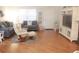 Bright living room with comfortable seating, a large entertainment center, and an open floor plan at 1310 Jimenez Ct, The Villages, FL 32159