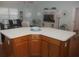 Bright living room is adjacent to the kitchen with a kitchen island at 1310 Jimenez Ct, The Villages, FL 32159