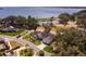 An elevated view of a single-Gathering home, well-manicured lawn, and tree-lined street in a Gathering neighborhood at 1350 Mosswood Dr, Leesburg, FL 34748