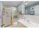 Well-maintained bathroom features a step-in shower with sliding doors, a vanity, and coordinated decor at 1350 Mosswood Dr, Leesburg, FL 34748