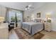 Charming bedroom with wooden floors and a large window at 1350 Mosswood Dr, Leesburg, FL 34748