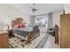 Cozy bedroom with a patterned rug and a comfortable wooden bed at 1350 Mosswood Dr, Leesburg, FL 34748