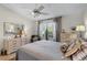 Light bedroom with a decorative lamp and a ceiling fan at 1350 Mosswood Dr, Leesburg, FL 34748