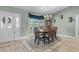 Elegant dining room featuring a chandelier, a large window, and a classic dining set with seating for six at 1350 Mosswood Dr, Leesburg, FL 34748