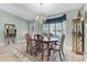 Elegant dining room featuring a chandelier, a large window, and a classic dining set with seating for six at 1350 Mosswood Dr, Leesburg, FL 34748