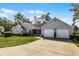 Charming residence with a two-car garage, mature trees, and a well-maintained lawn for curb appeal at 1350 Mosswood Dr, Leesburg, FL 34748
