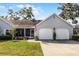 Well-kept residence featuring an attached two-car garage, a screened porch, and a lush green lawn at 1350 Mosswood Dr, Leesburg, FL 34748