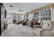 Bright living room featuring comfortable seating, large windows, and stylish decor, perfect for relaxing and entertaining at 1350 Mosswood Dr, Leesburg, FL 34748