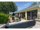 Back patio with comfortable seating and views of the lushly landscaped backyard at 1446 Arbor Trl, The Villages, FL 32162