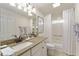 Well-lit bathroom features a granite countertop, tiled shower, and modern fixtures at 1446 Arbor Trl, The Villages, FL 32162