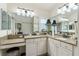Bright bathroom featuring double sinks, granite counters, vanity, and framed mirrors at 1446 Arbor Trl, The Villages, FL 32162