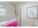 Modern bathroom with a glass-enclosed shower and neutral tile and framed artwork at 1446 Arbor Trl, The Villages, FL 32162