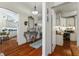 Hallway with hardwood floors leads to office and kitchen, offering a seamless transition at 1446 Arbor Trl, The Villages, FL 32162