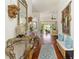 Hallway with hardwood floors leads to a living room, perfect for entertaining guests at 1446 Arbor Trl, The Villages, FL 32162