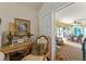 Home office area with desk, chair, and sliding glass doors to screened lanai at 1446 Arbor Trl, The Villages, FL 32162