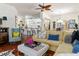 Open-concept living room with hardwood floors, comfortable seating, and a ceiling fan at 1446 Arbor Trl, The Villages, FL 32162