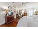 Spacious main bedroom with wood floors, dresser, television, and comfortable seating at 1446 Arbor Trl, The Villages, FL 32162