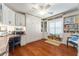 Multipurpose Office/Bedroom features built-in shelving, hardwood flooring, and a Murphy bed at 1446 Arbor Trl, The Villages, FL 32162